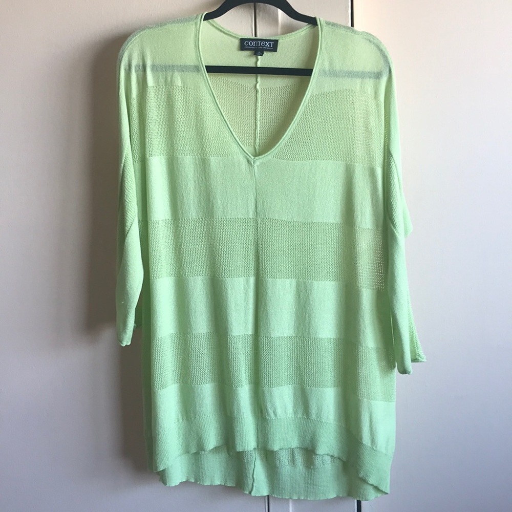 A sheer green sweater